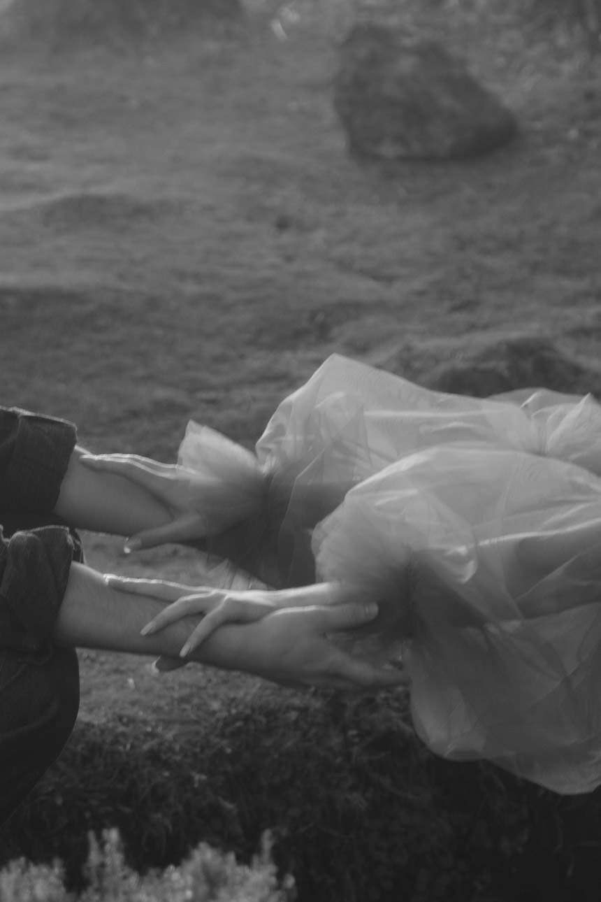 Bride and groom holding each other's forearms, showcasing a tender and connected moment during their wedding.