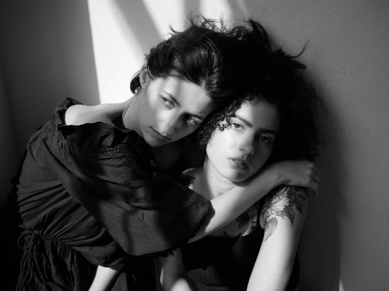 Two women during a fashion photoshoot at WUK in Vienna, showcasing modern style and urban elegance in a creative setting.